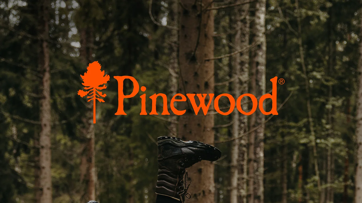 Pinewood logotyp med bakgrundsbild p&aring; skog